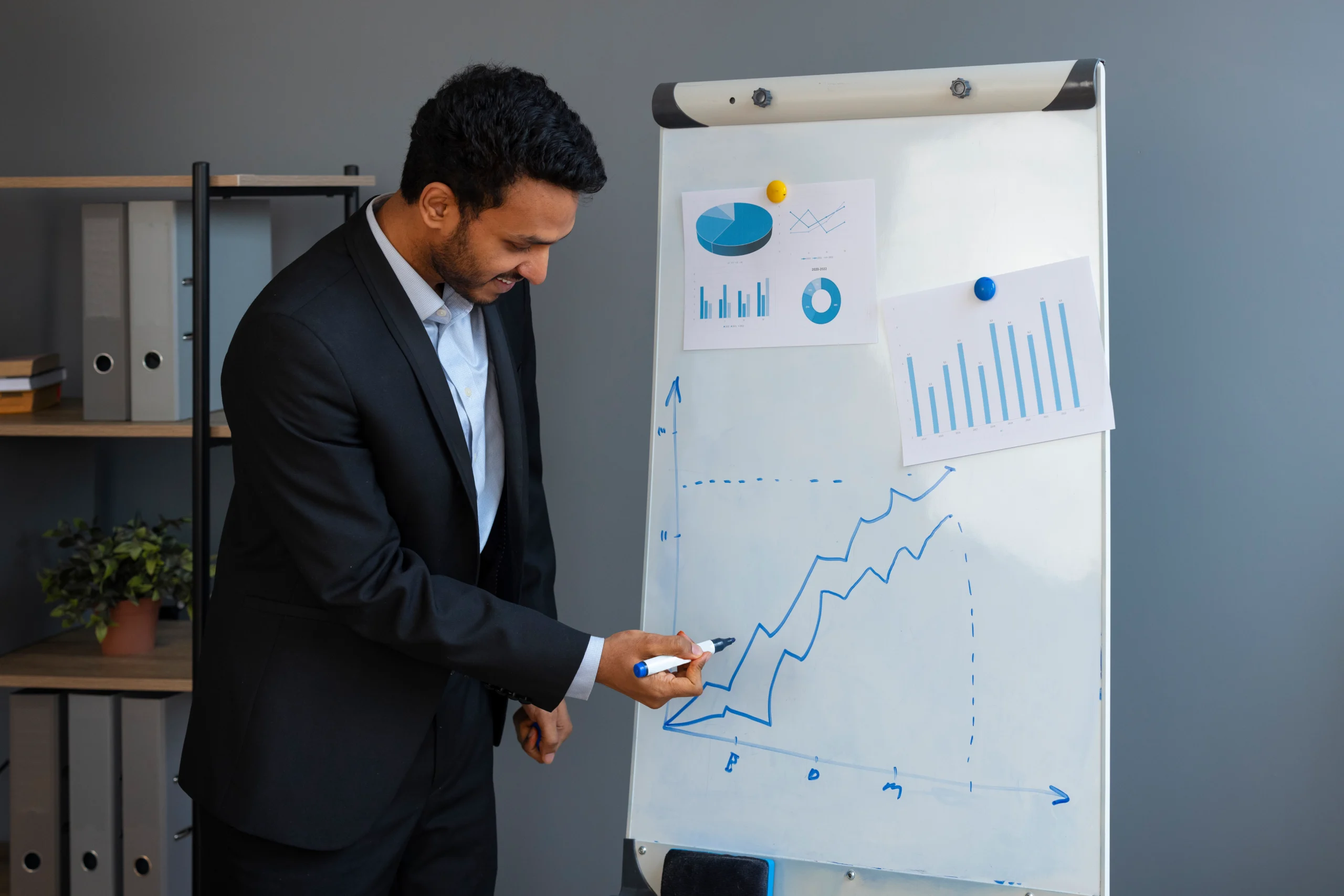 Business professional analyzing financial growth chart on whiteboard during presentation